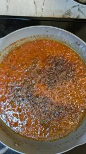 making the tomato sauce for eggplant mafrum