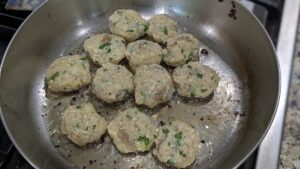 round shaped baltimore coddies ready to be fried